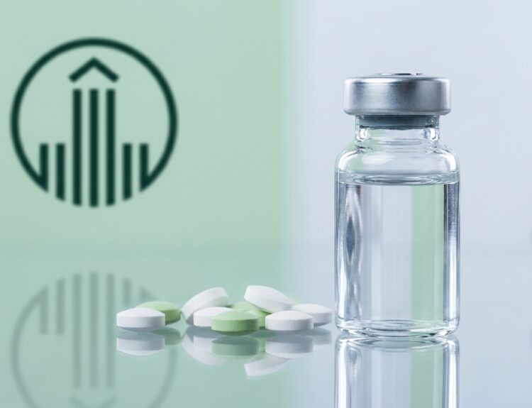 Medicine vial with a metal cap beside scattered white and green tablets on a reflective surface, with a green medical symbol in the background.